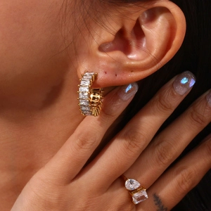 18K gold plated C-shaped hoop earrings with baguette-cut zircon on female model