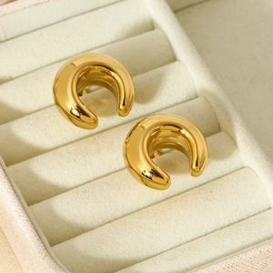 Close-up of geometric C-shaped 16K gold plated stainless steel earrings on velvet