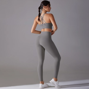 Detailed back view of a grey yoga set featuring a cross-strap bra and high-waisted leggings
