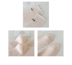 Detailed close-up of light beige knit calf socks showing quality stitching and cuff