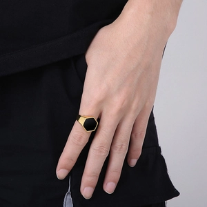 Close-up of a men's hexagonal black agate ring with a gold-plated stainless steel band