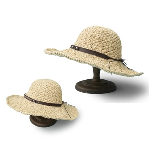 Women's wide brim straw sun hat with brown leather strap detail on a white background