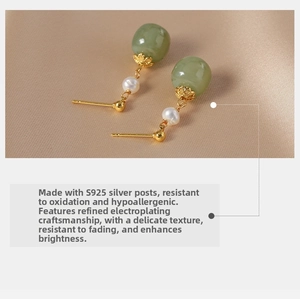 Detailed shot of vintage S925 silver stud earrings with green jade beads and pearls