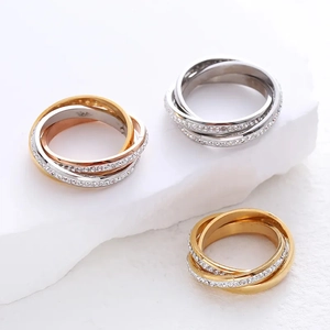 Three-tone interlocking ring set with cubic zirconia in gold, silver, and rose gold finish