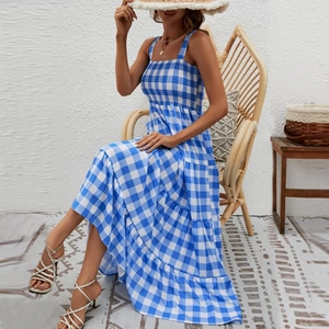 Close-up detail of blue striped smocked bodice and layered bohemian maxi dress fabric