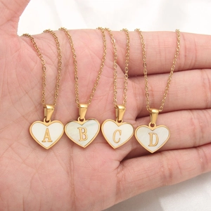 Delicate gold heart necklaces with white shell inlay and A B C D alphabet letters