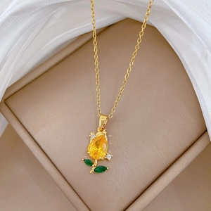 Champagne gold rose necklace with yellow flower pendant on elegant silk display