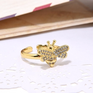 18k gold plated adjustable bee ring featuring shimmering zircon stones on lace background