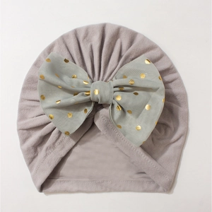 Detailed top view of lilac baby turban hat with a mint green gold foil polka dot bow