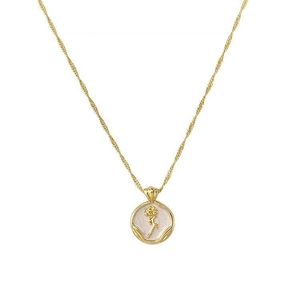 Macro detail of French vintage rose enamel pendant with elegant golden textured finish