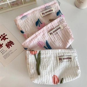 Three french embossed floral pouches with textured fabric and cherry tulip embroidery
