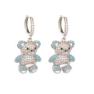 Detail of silver bear earrings with white zircon paving and blue gemstone accents