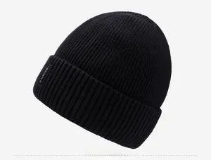 Detail view of the black ribbed knit beanie with side tag and warm thick texture