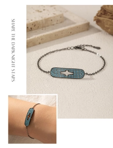Detail of S925 silver gunmetal chain bracelet featuring turquoise stones and star cutout