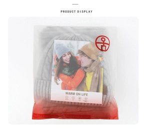 Detailed view of gray knit beanie and scarf set in branded frosted packaging bag