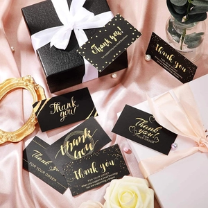 Elegant gold foil Thank You cards on pink silk background for small business packaging