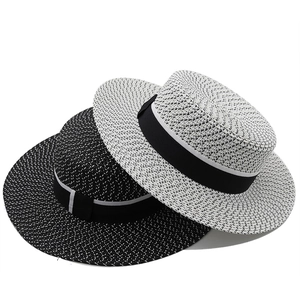 Classic boater hat with black wide ribbon band in woven salt and pepper straw texture