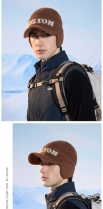 Close-up of brown knit beanie with earflaps and Boston embroidery for winter warmth