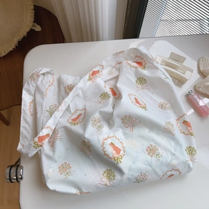 Detail of white cotton tote bag with vintage floral girl print on a minimalist desk