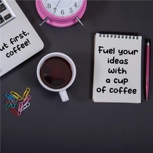 Flat-lay detail of letter stickers on notebook and laptop with coffee and pink alarm clock