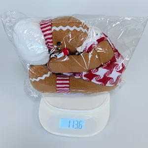 Detailed view of gingerbread man wine bottle cover on a scale weighing 113.6g
