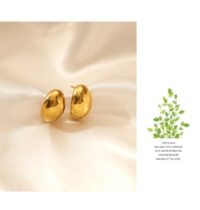 Polished 18K gold-plated dome stud earrings shown on soft silk with macro detail