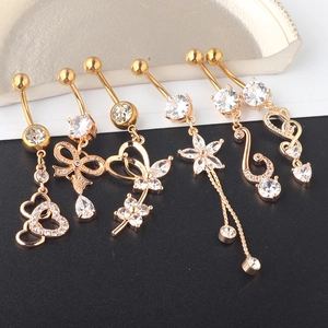 Detailed view of six gold-tone belly rings featuring heart, flower and butterfly charms