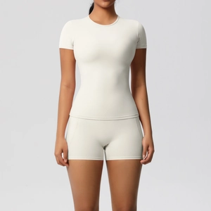 Close-up of creamy white slim-fit yoga short sleeve and high waist cycling shorts