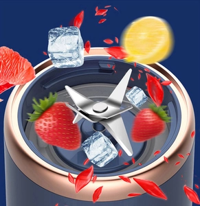 Action shot of rotating stainless steel blades in a portable blender with strawberries and ice