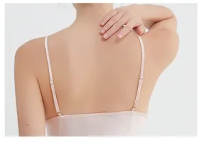 Detail of thin adjustable straps and straight back design on a pink silk camisole