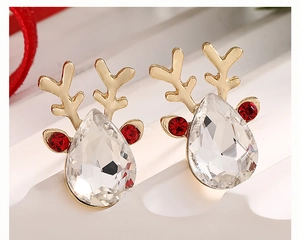 Macro shot of gold reindeer earrings with sparkling rhinestones for Christmas