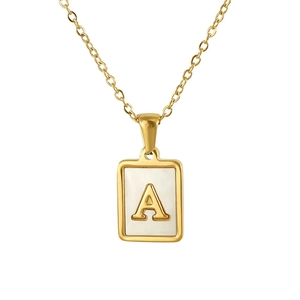 Close-up of golden necklace featuring a rectangular mother of pearl letter A pendant