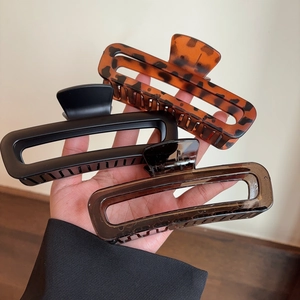 Three-piece set of large rectangular hair claws in leopard, black, and coffee tones