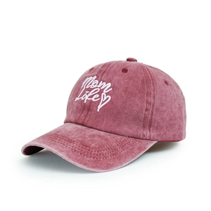 Detailed view of embroidery text on a washed cotton rose pink baseball cap