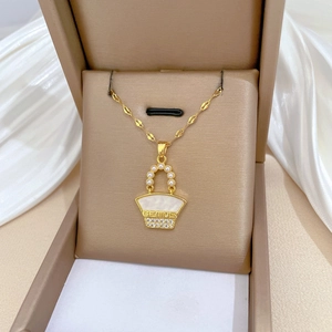 Gold handbag pendant necklace with white mother-of-pearl, pearls, and crystals on silk