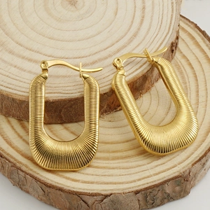 18K gold plated U-shaped ribbed square hoop earrings on natural wood blocks