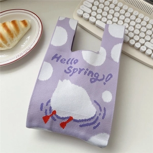 Detail of lavender knit handbag with polka dots and cartoon duck for Hello Spring decor