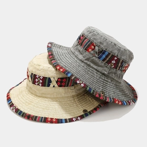 Washed canvas bucket hats in beige and dark grey with bohemian ethnic style woven bands