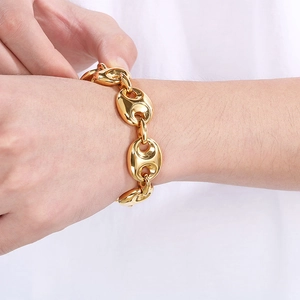 Detailed close-up of 18k gold plated coffee bean link bracelet worn on a wrist