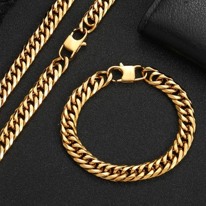 Macro detail of gold Cuban link chain with square press buckle on black texture