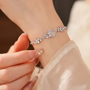 Elegant silver bracelet featuring a shimmering gourd pendant and sparkling zircon bow charm