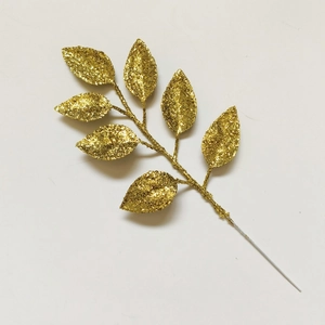 Close-up of golden glitter artificial leaves for Christmas tree decoration and DIY crafts