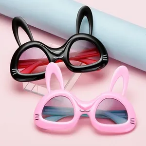 Detail of cartoon bunny ear sunglasses with gradient lenses in black and pink frames