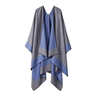 Detail of gray and blue reversible striped poncho showing soft textured fabric drape