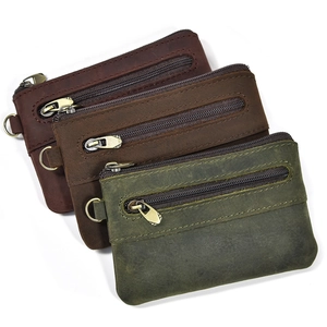 Detail of three vintage crazy horse leather coin purses with metallic zippers and D-rings