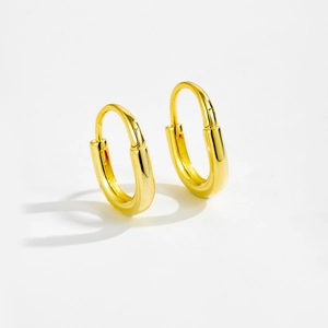 Minimalist S925 sterling silver oval hoop earrings in polished gold finish on white background