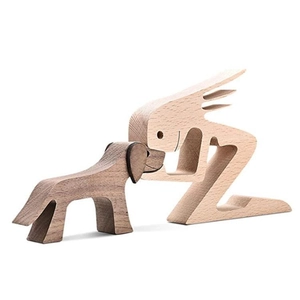 Close-up of handmade wooden sculpture showing a man and dog touching noses in natural grain