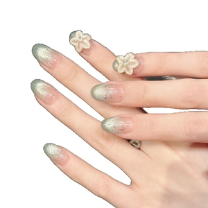 Ice blue cat-eye handmade press-on nails with 3D flower carvings and gradient finish