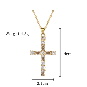 Macro view of gold titanium cross pendant with clear zircons and size specifications