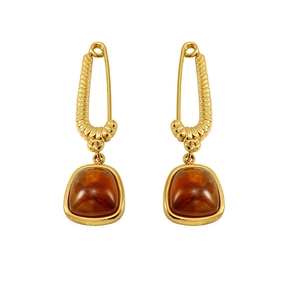 Detail of 18K gold pin earrings with square amber stone pendants on white background